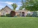 Beautiful single-story brick home featuring mature trees and lush green lawn at 6693 W May Apple Dr, McCordsville, IN 46055