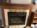A charming fireplace with a wooden mantel and tile surround is the focal point of this cozy living space at 670 Van Ave, Shelbyville, IN 46176