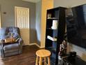 A cozy living room features hardwood floors, a comfortable recliner, and a modern entertainment center at 670 Van Ave, Shelbyville, IN 46176