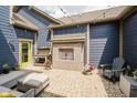 Outdoor patio featuring an outdoor fireplace, comfortable seating, and ambient string lights at 7077 Antiquity Dr, Carmel, IN 46033