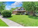 Beautiful brick home showcasing a lush green lawn, mature trees, and a welcoming front entrance at 7513 Pine Royal Dr, Indianapolis, IN 46256