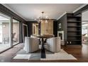 Stylish dining room with unique light fixture, fireplace, and sliding doors for seamless indoor-outdoor living at 7575 Central Ave, Indianapolis, IN 46240