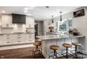 Modern kitchen with white cabinetry, herringbone backsplash, quartz countertop island and stainless appliances at 7575 Central Ave, Indianapolis, IN 46240