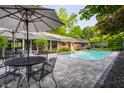 Inviting backyard pool area with patio, table, and chairs, perfect for outdoor relaxation and entertainment at 7575 Central Ave, Indianapolis, IN 46240