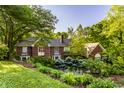 Charming two-story brick home with mature landscaping, garden, and brick trim at 8209 Beech Knoll, Indianapolis, IN 46256