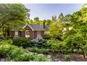 Charming two-story brick home with mature landscaping, garden, and brick trim at 8209 Beech Knoll, Indianapolis, IN 46256