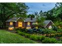 Charming two-story brick home with mature landscaping, brick trim, and exterior lighting at 8209 Beech Knoll, Indianapolis, IN 46256