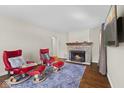 Cozy living room with a stone fireplace, comfortable seating, and hardwood flooring at 909 E Markwood Ave, Indianapolis, IN 46227