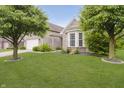 Well-manicured front yard and exterior of a brick home with a lovely bay window at 9598 N Mariners Crst, McCordsville, IN 46055