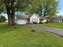 Cozy home featuring a driveway and attached garage at 1011 N 10Th St, Elwood, IN 46036