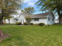 Well-maintained lawn and landscaped garden beds accent this cozy home at 1011 N 10Th St, Elwood, IN 46036