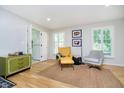 Bright living room featuring hardwood floors, plantation shutters, and neutral paint at 1045 Millwood Ct, Indianapolis, IN 46260