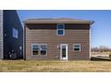 Spacious backyard featuring brown siding, a door entrance, and plenty of room for outdoor activities at 1105 Lona Dr, Martinsville, IN 46151