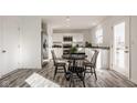 Bright kitchen with white cabinets, stainless steel appliances, and a dining area perfect for Gathering meals at 1105 Lona Dr, Martinsville, IN 46151