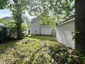 A leafy backyard, ready for landscaping and gardening; includes a detached garage at 1153 Dawson St, Indianapolis, IN 46203