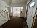 Foyer with original staircase and transom window over the front door; ready for restoration at 1153 Dawson St, Indianapolis, IN 46203