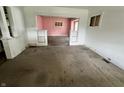 Open-concept living room with decorative columns, ready for renovation and your personal touches at 1153 Dawson St, Indianapolis, IN 46203
