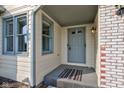 Inviting entryway with a classic-style door, sidelight windows, and brick accents at 12258 Charing Cross Rd, Carmel, IN 46033