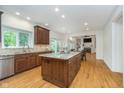 Spacious kitchen with custom cabinets, granite counters, island and stainless steel appliances at 12563 Sandstone Run, Carmel, IN 46033