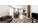 Open-concept living space with wood floors and sightlines into the kitchen at 1342 N Oakland Ave, Indianapolis, IN 46201