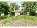 Large backyard with a detached garage and garden area at 1440 Brandt Dr, Indianapolis, IN 46241