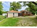 Expansive backyard featuring a detached garage and well-maintained lawn at 1440 Brandt Dr, Indianapolis, IN 46241