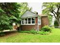 Charming brick home with a well-maintained lawn and lush greenery at 1440 Brandt Dr, Indianapolis, IN 46241