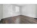 Bright living room with gray walls, wood-look floors and a beautiful door with intricate glass detail at 1521 N Gladstone Ave, Indianapolis, IN 46201
