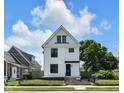 Charming two-story home with a black fence, black framed windows, and a well-manicured front yard at 19 E Regent St, Indianapolis, IN 46225