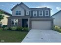 Beautiful two-story home with brick and siding, lush lawn, and a two-car garage at 2263 S Carlota Dr, New Palestine, IN 46163