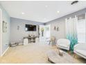 Bright living room with carpet, a decorative fireplace, TV, and ample seating with natural lighting at 2353 E 10Th St, Anderson, IN 46012