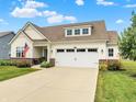 Inviting single-Gathering home boasting a manicured lawn, complemented by an attached two-car garage at 247 Verdant Dr, Cicero, IN 46034