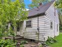 Exterior rear view of a home with weathered siding and an overgrown yard at 2606 Raible Ave, Anderson, IN 46011