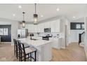 Bright kitchen featuring white cabinets, stainless steel appliances, and a large island with bar seating at 2693 Penn Ave, Plainfield, IN 46168