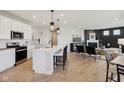 Open floor plan with kitchen island open to living room and fireplace at 2693 Penn Ave, Plainfield, IN 46168