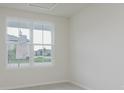 Bright bedroom with neutral carpet, white walls, large window offering neighborhood views at 2705 Penn Ave, Plainfield, IN 46168