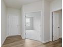 Bright entryway featuring wood floors, white trim and doors, and a view to the front room at 2705 Penn Ave, Plainfield, IN 46168