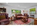Bright and airy living room with a stylish rug, comfortable seating, and natural light at 305 N 1100 E, Zionsville, IN 46077