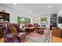 Inviting living room with large windows, hardwood floors, and comfortable seating at 305 N 1100 E, Zionsville, IN 46077