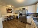Eat-in kitchen featuring newer cabinets and appliances, and hardwood floors at 309 Arlington Dr, Whiteland, IN 46184