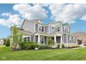 Charming exterior showcasing a well-kept lawn and professional landscaping at 3316 Shelborne Woods Pkwy, Carmel, IN 46032