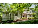 Attractive two-story home featuring lush landscaping and a brick-paved walkway to the front door at 410 Somerset W Dr, Indianapolis, IN 46260