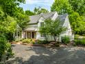 Beautifully landscaped home with brick-lined drive and walkway leading to a covered front porch at 410 Somerset W Dr, Indianapolis, IN 46260