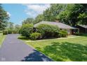 A beautiful driveway with mature landscaping enhancing the curb appeal at 4232 Linden Ln, Anderson, IN 46011