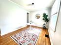 Cozy dining room with hardwood floors, a modern rug, and a white table at 4714 Crestview Ave, Indianapolis, IN 46205