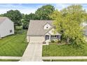 Aerial view of a well-maintained home with a lush green lawn and mature trees in a residential neighborhood at 4818 Arabian Run, Indianapolis, IN 46228