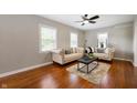 Bright living room with hardwood floors, neutral walls, stylish sofas, and ample natural light at 5232 E 10Th St, Indianapolis, IN 46219