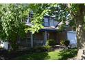 Traditional two-story home with inviting front porch and swing for relaxing outdoors at 6056 Blackley Ct, Indianapolis, IN 46254