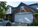 Exterior featuring a wide garage, brick details, and a well-kept lawn at 6056 Blackley Ct, Indianapolis, IN 46254