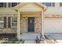 Covered entrance with brickwork, leading to an attached garage at 6213 Selago Dr, Indianapolis, IN 46203
